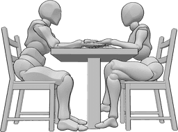 Referência de poses- Pose romântica sentada - Uma mulher e um homem estão sentados numa mesa em frente um do outro e de mãos dadas