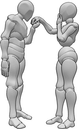 Référence des poses- Pose surprise de la main qui s'embrasse - Une femme et un homme se tiennent l'un devant l'autre et l'homme embrasse la main de la femme, qui est surprise.