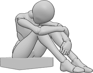 Referência de poses- Posição triste sentada abraçando os joelhos - A mulher triste está sentada, abraçando os joelhos, olhando para baixo